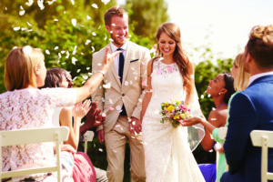 Guests Throwing Confetti Over Bride And Groom At Wedding