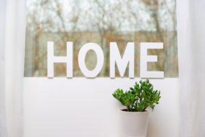 home written in wooden letters in house on the window seal