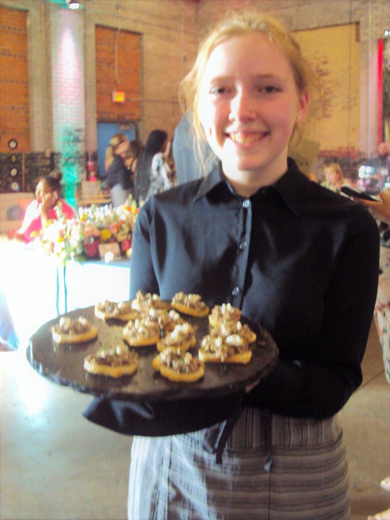 Woman serving hors d’oeuvres.