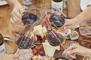 wine glasses with cheese and meats