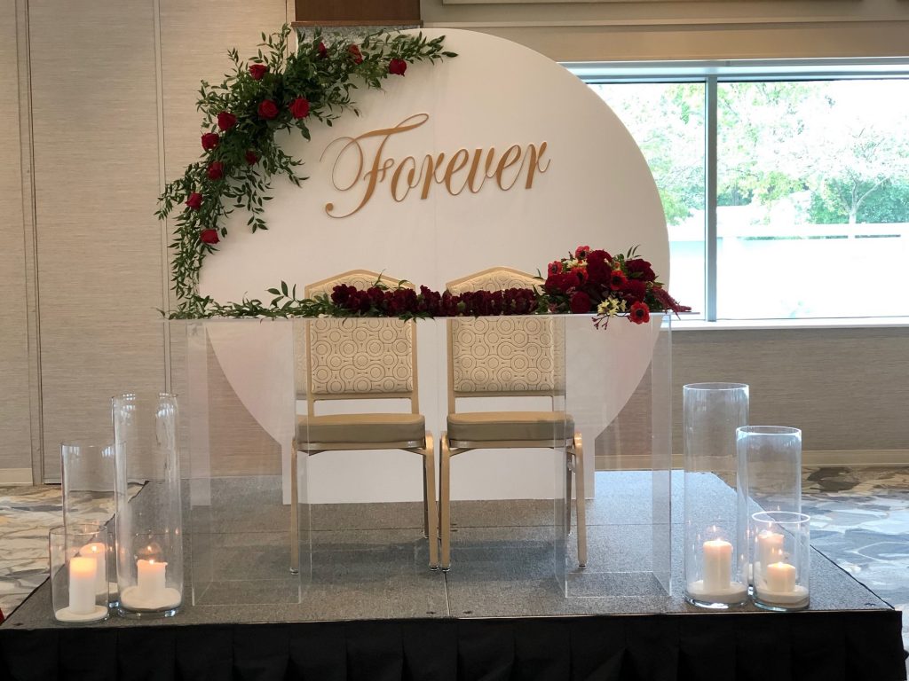 Clear ghost-tables and chairs with flowers for wedding reception from Christian Lei Events.
