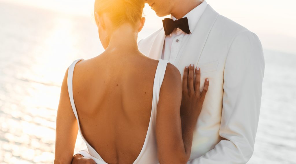 Wedding Couple on water at sunset